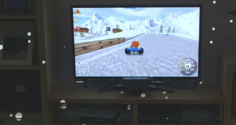 A screenshot from Microsoft Illumiroom with Mozilla from SuperTuxKart 0.8 driving in Northern Resort and snow falling effect on the walls surrounding the TV screen